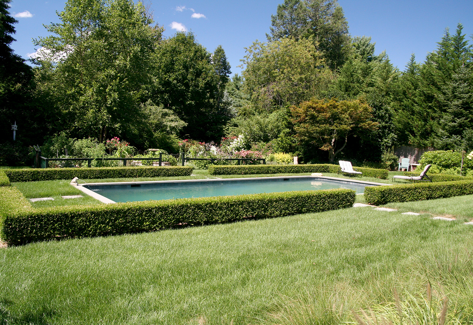 Gunite pool with a bluestone pathway, formal hedge and vegetable garden.