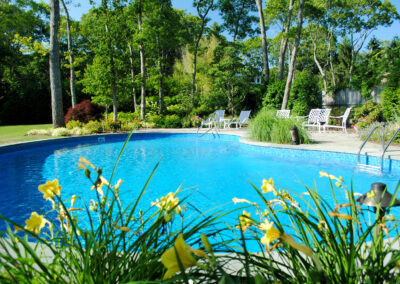 Enjoy the outdoors with a pool surrounded by flowering perennials.