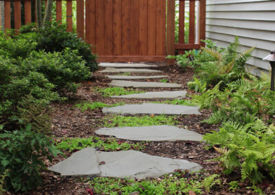 Custom wood gate and a natural stone garden path.