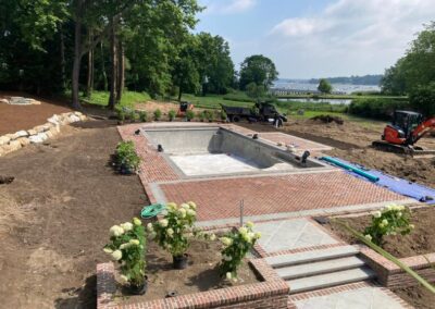 Pool construction and landscaping project in progress.